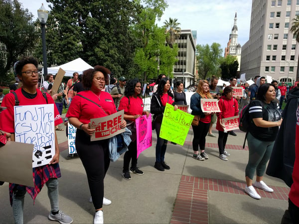 Hundreds of red-shirted CSU students and faculty gathered at the Capitol to call for more state funding.